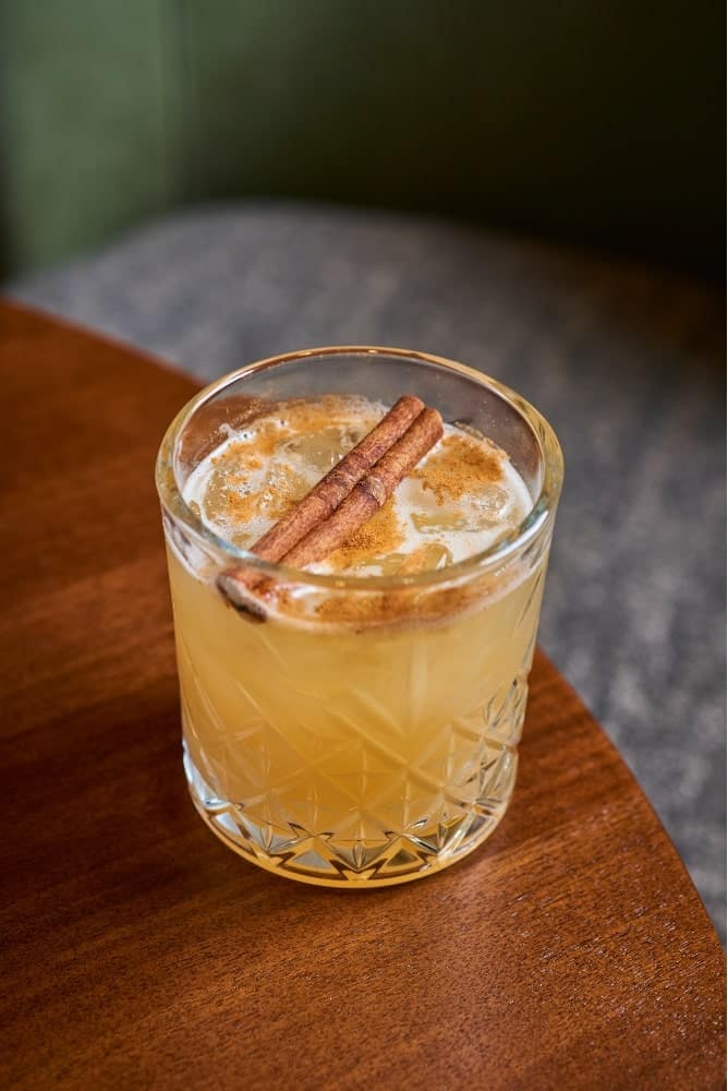 Craft cocktail with garnish at The Dime